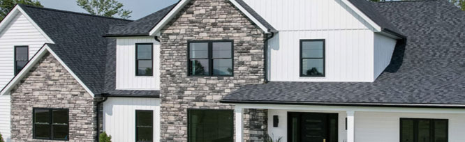 Image of home showing siding, stone, and roofing